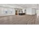 Spacious living room featuring wood flooring, gray cabinets, stainless appliances and kitchen island at 17907 Palmiste Dr, Bradenton, FL 34202