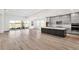Open-concept living area with wood floors, large windows, and seamless flow to the kitchen at 17907 Palmiste Dr, Bradenton, FL 34202