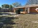 View of the home's backyard, featuring a small shed and lush lawn at 1804 Bayshore Gardens Pkwy, Bradenton, FL 34207