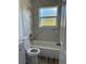 Updated bathroom featuring a modern toilet, shower head, and marble tiled shower at 1804 Bayshore Gardens Pkwy, Bradenton, FL 34207