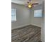 Naturally lit bedroom featuring wood-look flooring, a ceiling fan and a bright window at 1804 Bayshore Gardens Pkwy, Bradenton, FL 34207