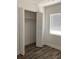 Bright bedroom featuring an open closet, window with blinds, and wood-look flooring at 1804 Bayshore Gardens Pkwy, Bradenton, FL 34207