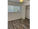 Bright bedroom with natural light, featuring a large window and wood-look flooring at 1804 Bayshore Gardens Pkwy, Bradenton, FL 34207