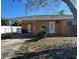 Charming single-story home with a covered carport and partially shaded front yard at 1804 Bayshore Gardens Pkwy, Bradenton, FL 34207