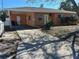 Cozy home featuring a covered carport, orange siding, and a well-maintained front yard at 1804 Bayshore Gardens Pkwy, Bradenton, FL 34207