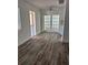 Bright living room showcasing the luxury vinyl plank flooring and fresh paint throughout at 1804 Bayshore Gardens Pkwy, Bradenton, FL 34207