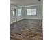 Bright and airy living room with fresh paint, modern lighting, and luxury vinyl plank floors at 1804 Bayshore Gardens Pkwy, Bradenton, FL 34207