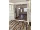 Bright living room with beautiful wood-look floors, fresh paint, and stylish french doors at 1804 Bayshore Gardens Pkwy, Bradenton, FL 34207