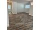 Spacious living area featuring wood-look floors, fresh paint and modern lighting at 1804 Bayshore Gardens Pkwy, Bradenton, FL 34207