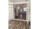 Bright living room with beautiful wood-look floors, fresh paint, and stylish french doors at 1804 Bayshore Gardens Pkwy, Bradenton, FL 34207