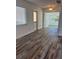 Bright living room showcasing luxury vinyl plank flooring and ample natural light at 1804 Bayshore Gardens Pkwy, Bradenton, FL 34207