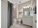 Bright bathroom with a shower-tub combo, white vanity, and neutral tile flooring at 18113 Gawthrop Dr # 103, Bradenton, FL 34211