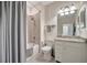 Well-lit bathroom featuring a shower-tub and granite vanity with white cabinets and fixtures at 18113 Gawthrop Dr # 103, Bradenton, FL 34211