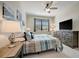 Cozy bedroom featuring natural light, with a TV and wooden dresser for storage at 18113 Gawthrop Dr # 103, Bradenton, FL 34211