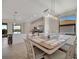 Open dining area featuring tile flooring, an elegant light fixture, and direct access to the kitchen at 18113 Gawthrop Dr # 103, Bradenton, FL 34211