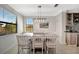 Bright dining room features a light-colored table with seating for six and a built-in bar at 18113 Gawthrop Dr # 103, Bradenton, FL 34211
