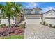 Charming two-story home with a two-car garage, a brick driveway and lush landscaping at 18113 Gawthrop Dr # 103, Bradenton, FL 34211