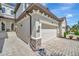 Side exterior view of garage and front door with stone accents and brick driveway at 18113 Gawthrop Dr # 103, Bradenton, FL 34211