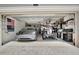Organized garage with a car, golf cart, and storage, ideal for car enthusiasts and outdoor adventurers at 18113 Gawthrop Dr # 103, Bradenton, FL 34211