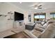 The living room features a ceiling fan, tv and access to outdoor living space at 18113 Gawthrop Dr # 103, Bradenton, FL 34211