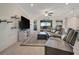 The living room features a ceiling fan, tv and access to outdoor living space at 18113 Gawthrop Dr # 103, Bradenton, FL 34211