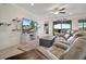 The living room features a ceiling fan, tv and access to outdoor living space at 18113 Gawthrop Dr # 103, Bradenton, FL 34211