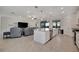 Open concept living space features a large kitchen island, living room, and access to outdoor space at 18113 Gawthrop Dr # 103, Bradenton, FL 34211