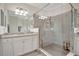 Beautiful main bathroom with large walk-in shower, tile floor, granite counters, and dual sinks at 18113 Gawthrop Dr # 103, Bradenton, FL 34211