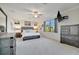 This main bedroom features a ceiling fan, dresser, luxury carpet and a large window at 18113 Gawthrop Dr # 103, Bradenton, FL 34211