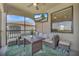This screened patio has a TV, seating, and golf course views, creating an outdoor retreat for relaxation and entertainment at 18113 Gawthrop Dr # 103, Bradenton, FL 34211