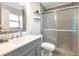 Bright bathroom features gray vanity, a frosted glass shower, and modern fixtures for a comfortable and stylish space at 2021 Central Ave, Sarasota, FL 34234