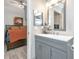 Modern bathroom with a single sink vanity, mirror, and view to bedroom at 2021 Central Ave, Sarasota, FL 34234