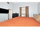 Bedroom featuring a large bed, a television, and natural light from a window at 2021 Central Ave, Sarasota, FL 34234