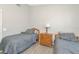Bright bedroom featuring wood laminate flooring, two twin beds, and a neutral color scheme for a comfortable space at 2021 Central Ave, Sarasota, FL 34234