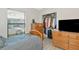 Bedroom with wood laminate floors, window with blinds, closet and dresser set at 2021 Central Ave, Sarasota, FL 34234