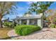Home exterior boasting well-kept hedges and a circular brick driveway, enhancing curb appeal at 2021 Central Ave, Sarasota, FL 34234