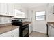 Well-lit kitchen featuring white cabinetry, modern appliances, and ample counter space at 2021 Central Ave, Sarasota, FL 34234