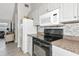 Bright kitchen with white cabinets, modern appliances, and stylish backsplash at 2021 Central Ave, Sarasota, FL 34234