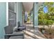 Comfortable outdoor seating on the porch, offering a relaxing space with shade and neighborhood views at 2021 Central Ave, Sarasota, FL 34234