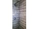 Close up of a shower featuring horizontal wood-look tile, chrome shower head and shower controls at 2021 Central Ave, Sarasota, FL 34234