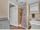 The bathroom features an updated walk-in shower, vinyl flooring, and white vanity at 2207 Holyoke Ave, Bradenton, FL 34207