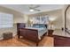 Cozy bedroom with a ceiling fan, window and a traditional style dark wood bedroom set at 2207 Holyoke Ave, Bradenton, FL 34207