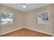 Empty bedroom with two large windows allowing for plenty of natural light and hardwood floors at 2207 Holyoke Ave, Bradenton, FL 34207