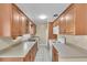A traditional kitchen featuring light wood cabinets, light countertops, and white appliances at 2207 Holyoke Ave, Bradenton, FL 34207