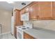 Traditional kitchen with wooden cabinetry, white countertops and appliances at 2207 Holyoke Ave, Bradenton, FL 34207