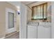 The laundry room features updated appliances and durable laminate flooring at 2207 Holyoke Ave, Bradenton, FL 34207