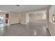 Open-concept living room with neutral paint, durable flooring, and ample natural light flowing into adjacent rooms and kitchen at 2207 Holyoke Ave, Bradenton, FL 34207