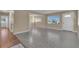 Bright and open living room featuring large windows, neutral paint, ceiling fan and durable flooring that provides a clean aesthetic at 2207 Holyoke Ave, Bradenton, FL 34207