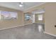 Spacious living room featuring large windows, neutral paint, ceiling fan and durable flooring that provides a clean aesthetic at 2207 Holyoke Ave, Bradenton, FL 34207