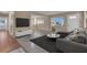 Bright living room with large windows, neutral paint, ceiling fan and stylish furnishings creates an inviting and comfortable atmosphere at 2207 Holyoke Ave, Bradenton, FL 34207